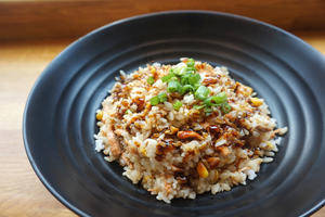 bowl of cooked brown rice with green onion on top