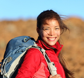 Smiling young woman hiking.