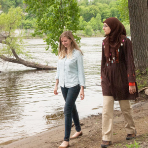 two women walking by river