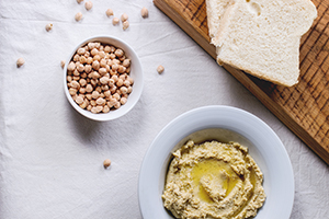 bowl of hummus next to a bowl of chickpeas