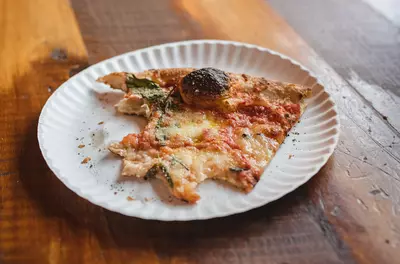 plate with half-eaten piece of pizza