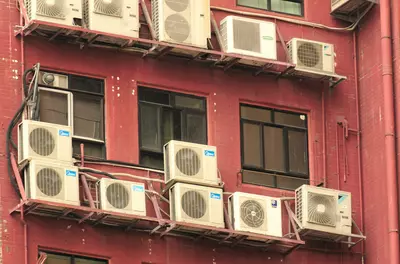Outdoor view of apartment complex with air conditioning units outside every window