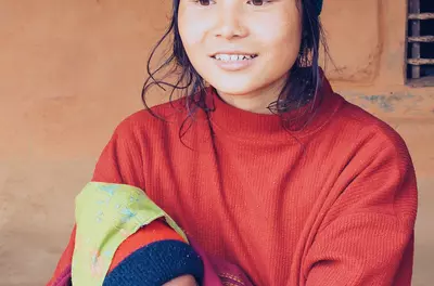 young smiling woman holding a small baby