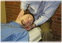 Man receiving neck adjustment