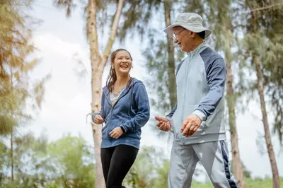 woman and grandfather walking in the park