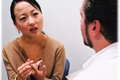 A doctor talking with a female patient. 