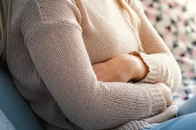 Person experiencing abdominal pain.