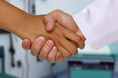 patient shaking hands with doctor