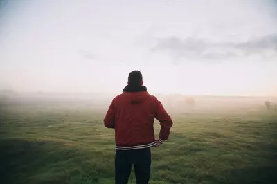 man facing open field