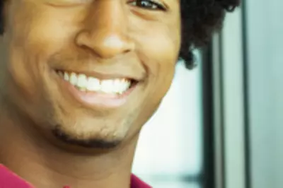 man in red polo shirt smiling at the camera