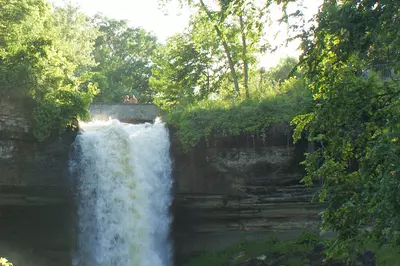 a calming waterfall with trees surrounding