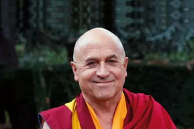 Image of Ricard in Tibetan monk robes on dark background