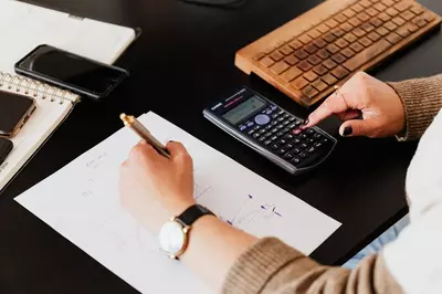 hands and calculator doing finances