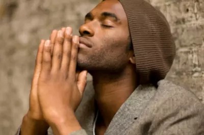 man with hands in prayer