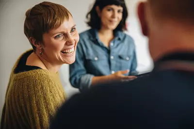 woman talking to two friends