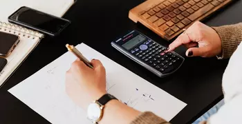 hands and calculator doing finances