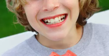 young boy smiling with watermelon