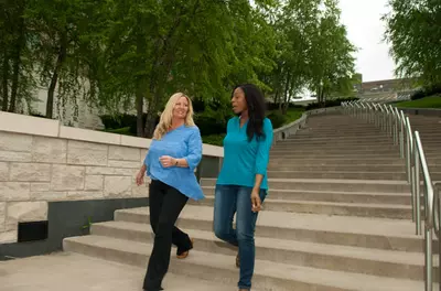 two women walking down outdoor steps together
