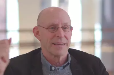 Still of Michael Pollan speaking to the camera in front of a light background