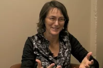 barbara fredrickson speaking in front of a beige background