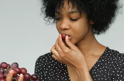 woman eating grapes