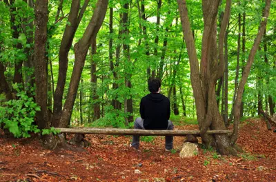 man relaxing on a bench